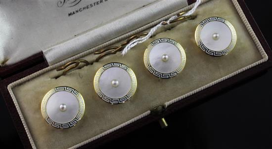 A cased early 20th century four piece 18ct gold, white enamel and mother of pearl dress stud set,